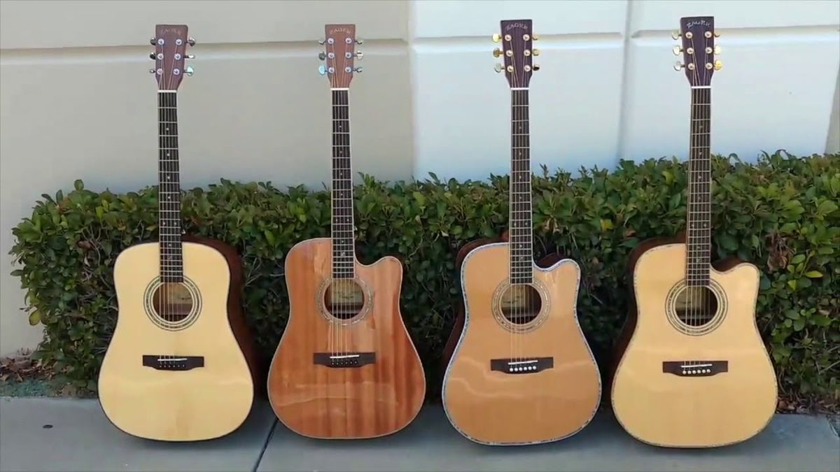 Four Zager acoustic guitars standing side by side against an outside wall