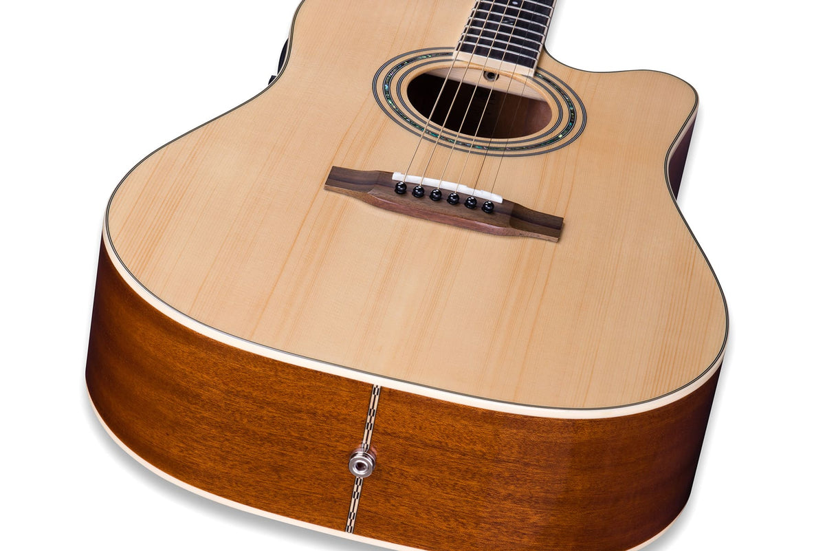 The rosewood bridge of a Zager acoustic with the six strings seated over it